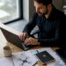 Un entrepreneur crée son compte AlphaTango assis à son bureau.