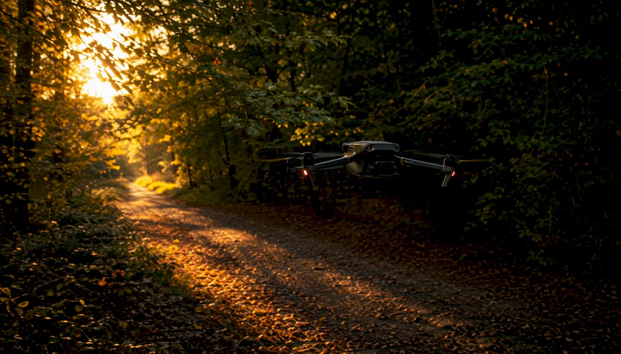 Le DJI Mavic 3 navigue avec aisance à travers un sentier forestier, évitant les obstacles avec une grande précision.