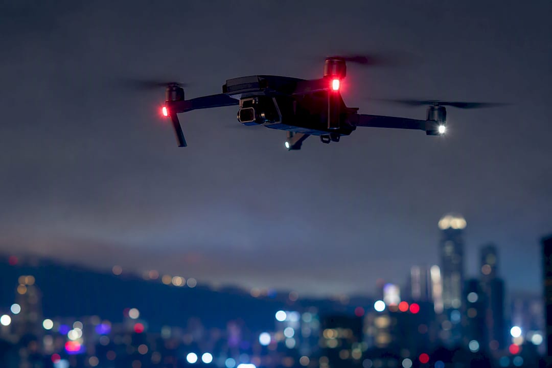 Drone éclairé par ses feux de vol de nuit
